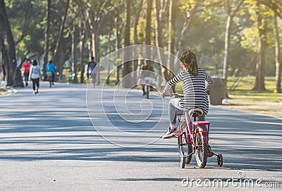 Child girl practicing biking bicycle Stock Photo