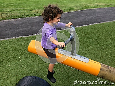 Child girl rides on Seesaw Stock Photo