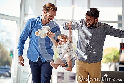 Child girl at shopping with gay parents.family having fun at shopping Stock Photo