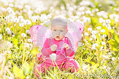 Child girl sitting among dandelions Stock Photo