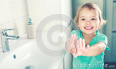 Child girl smiling face wahing and showing clean hands Stock Photo