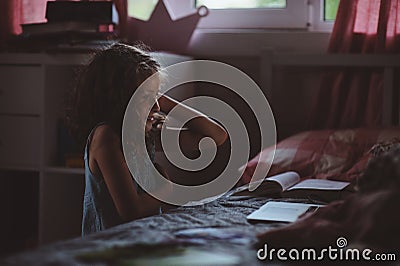 Child girl using laptop and watching movies at night alone in her room Stock Photo