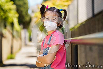 Child girl wearing a protection mask against coronavirus during Covid-19 pandemic Stock Photo