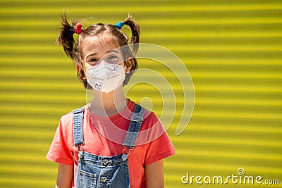 Child girl wearing a protection mask against coronavirus during Covid-19 pandemic Stock Photo