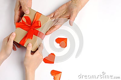 A child gives a gift to a grandmother with love Stock Photo