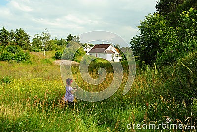 Child in green field Stock Photo