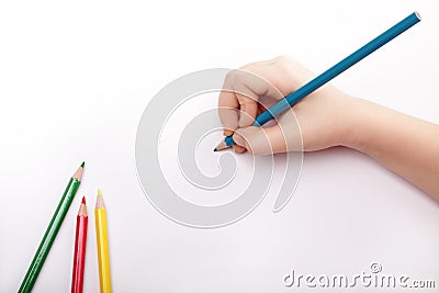 Child hand draws a blue pencil Stock Photo