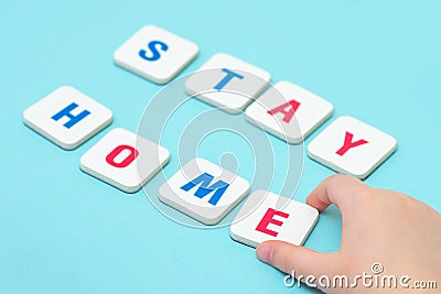 Child hand makes word STAY HOME Stock Photo