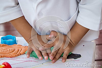 Child hand playing with clay Stock Photo