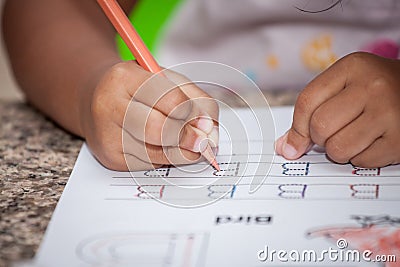 Child hand writing her homework Stock Photo