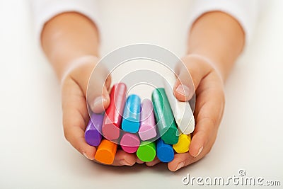 Child hands with colorful clay bars Stock Photo