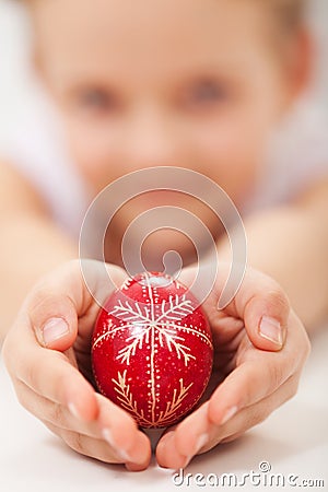 Child hands holding traditional decorated easter egg Stock Photo