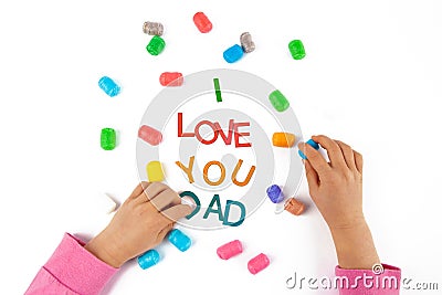 Child hands made the words I love You Dad. Stock Photo