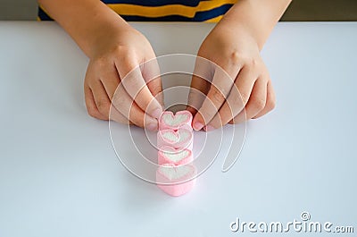 Child hands play jellys on white table Stock Photo