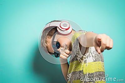 Child with headphones of music and funny expression Stock Photo