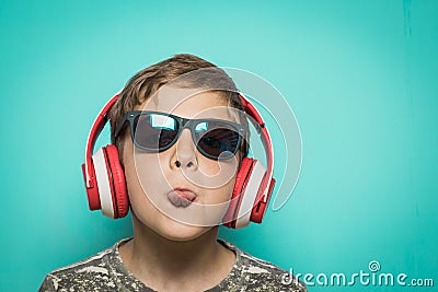 Child with headphones of music and funny expression Stock Photo