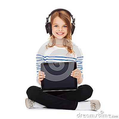 Child with headphones showing tablet pc Stock Photo