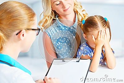 Child with his mother afraid of visit to doctor Stock Photo