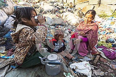 Child and his parents during lunch in break between working on dump. Editorial Stock Photo