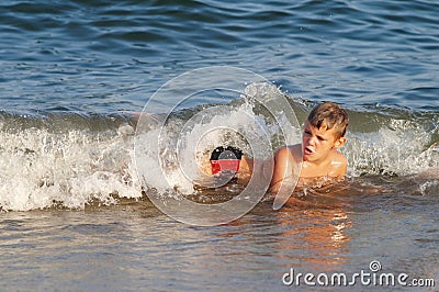 Child hit by a sea wave Stock Photo