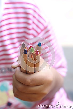 Child hold color pencils Stock Photo