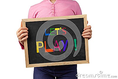 Child holding blackboard saying Let`s Play. Stock Photo