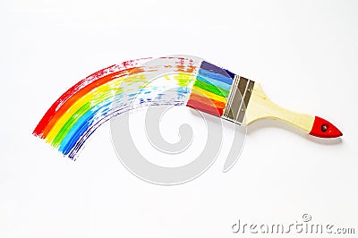 The child is holding the brush. The kid paints a maple leaf painted in all the colors of the rainbow. Multicolored arc. Stock Photo