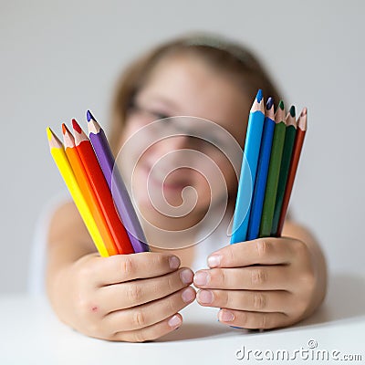 Child holding crayons Stock Photo