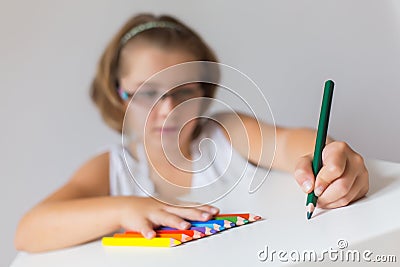 Child holding crayons Stock Photo