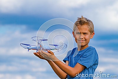 Child holding drone outdoors at summer day Stock Photo