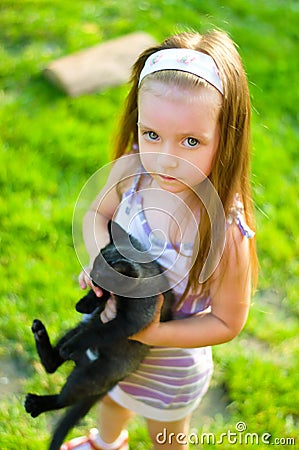 Child holding kitten Stock Photo