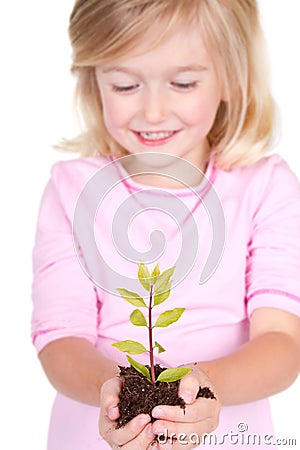 Child holding a plant Stock Photo