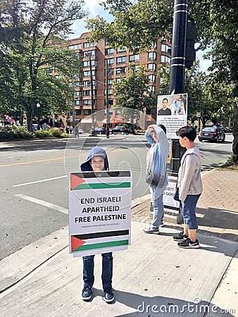 A child holding a poster asking to free Palestine Editorial Stock Photo