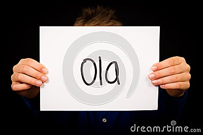 Child holding sign with Portuguese word Ola - Hello Stock Photo