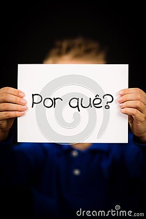 Child holding sign with Portuguese word Por Que - Why Stock Photo