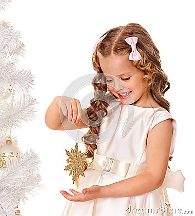 Child holding snowflake to decorate Christmas tree . Stock Photo