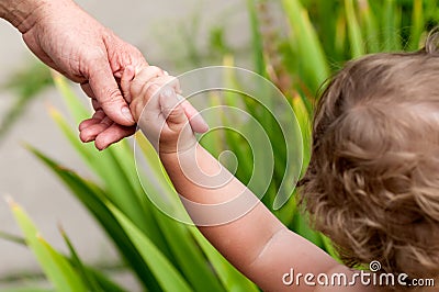 Child holds for finger moms Stock Photo