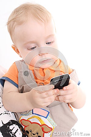 The child holds a mobile phone in hands Stock Photo