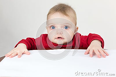 The child holds white sheets of paper in his hands Stock Photo
