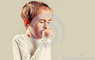 Child is ill, he coughs. Treatment of colds and flu. Boy coughing sick colds sneezing cough. Child got sick with a virus Stock Photo