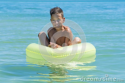 Child with inflatable ring in sea Stock Photo