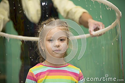 Child inside the soap bubble. Editorial Stock Photo