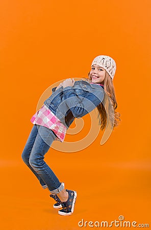 Child in jeans suit, hat, plaid shirt balance tiptoe Stock Photo