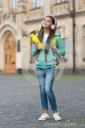 Child with juice or water bottle in earphones care health and body hydration, water balance Stock Photo