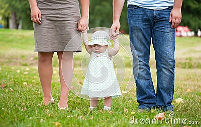 Child keeps for hands of parents Stock Photo