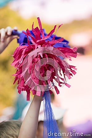 Child keeps pompons for cheerleading Stock Photo