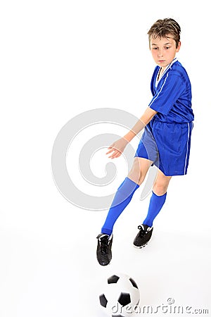 Child kicking ball Stock Photo