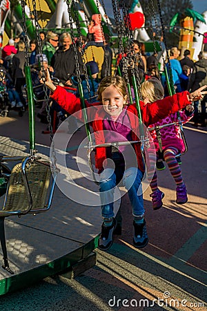 Child on kirtag in kettenkarusell, carousel, ka Stock Photo
