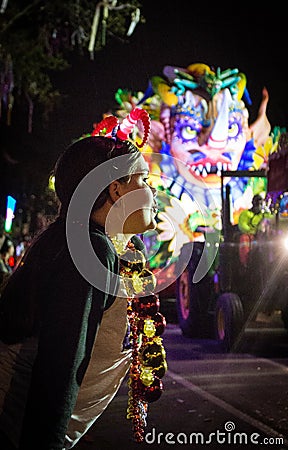 A Child Waits for Parade Throws During the Orpheus Parade Editorial Stock Photo