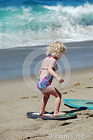 Child learning how to skimboard in Laguna Beach, CA Editorial Stock Photo